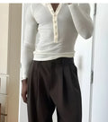 Cream coloured men's ribbed long-sleeve henley top with button placket neckline
