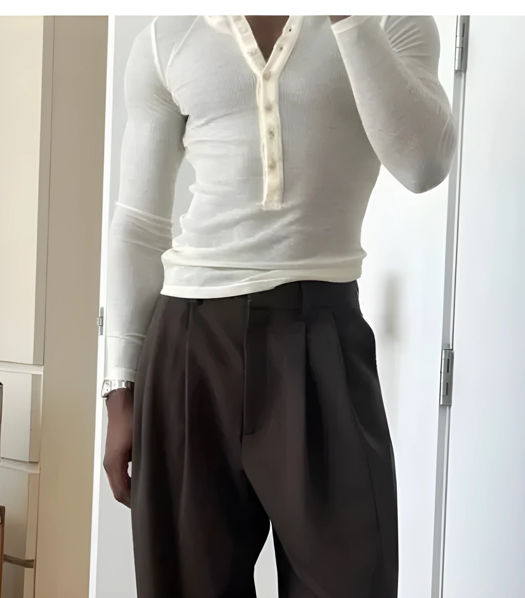 Cream coloured men's ribbed long-sleeve henley top with button placket neckline