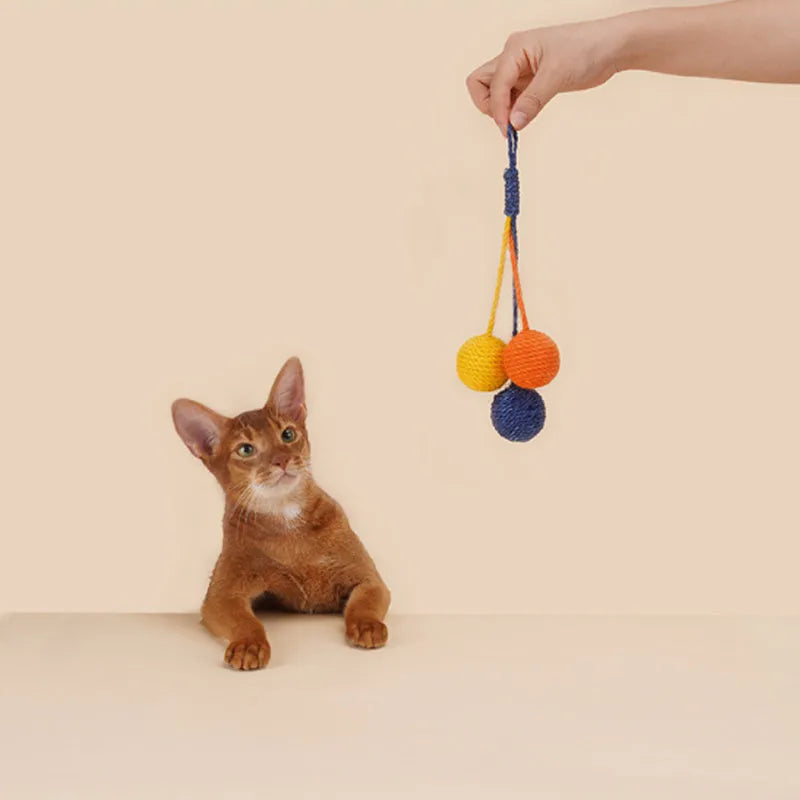 Four-piece cat toy set with teaser stick, catnip ball, and self-play toys on blue background