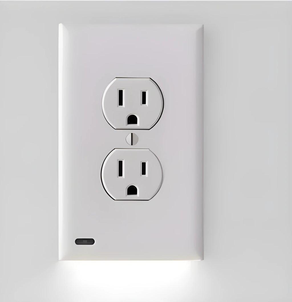 White plug-in LED sensor night light installed in a wall socket