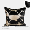 Black gold abstract patterned square decorative pillow with a soft flannel texture on a grey sofa.