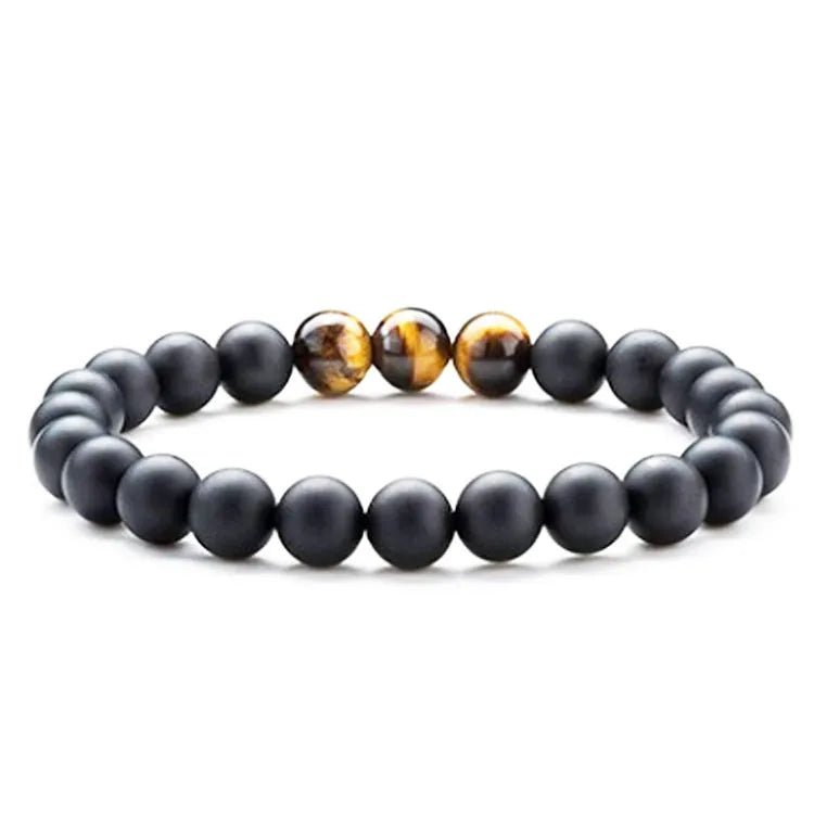 Matte black agate tiger eye bead couple bracelets with geometric design on a neutral background.