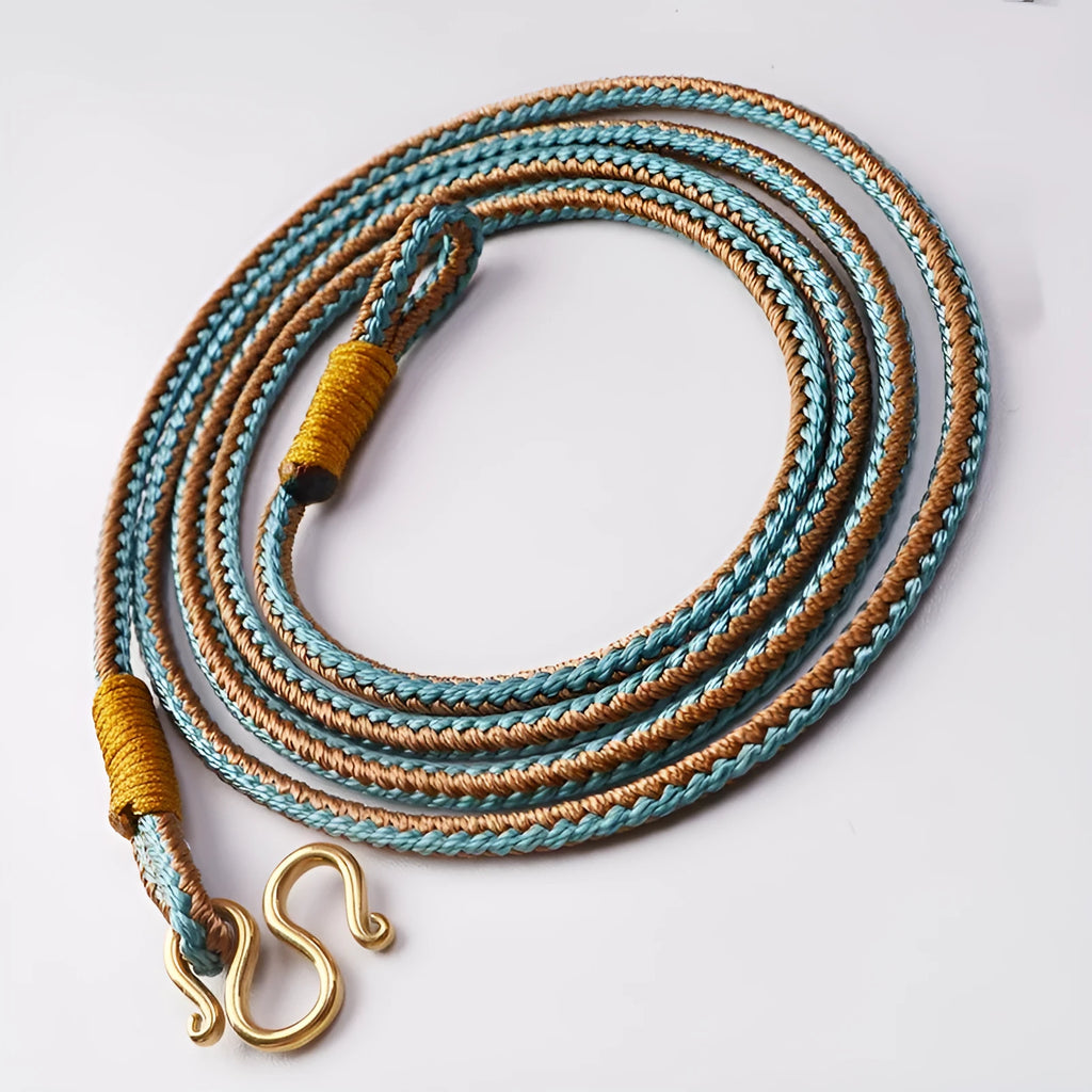 Gold and silver Thangka Peace Buckle pendant with imitation pearl and mixed gem inlays on a necklace.