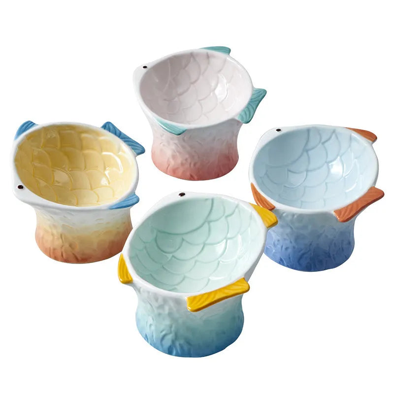Blue fish-shaped ceramic cat bowl with elevated base and tilted food well