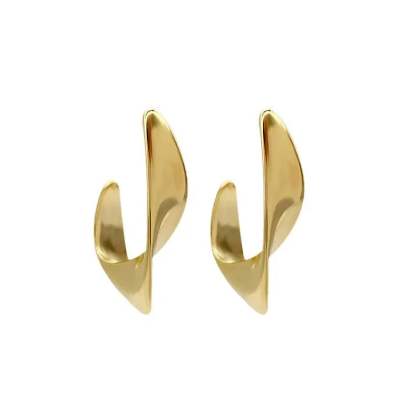 Metal twisted geometric earrings with electroplated gold or silver finish showing round design elements