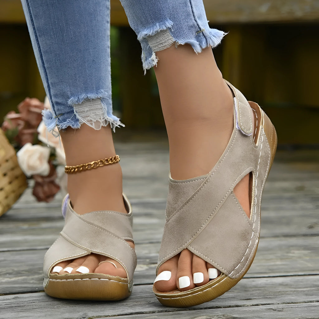 Women's brown Roman platform sandals with skirt detail and Velcro strap on a rubber sole.