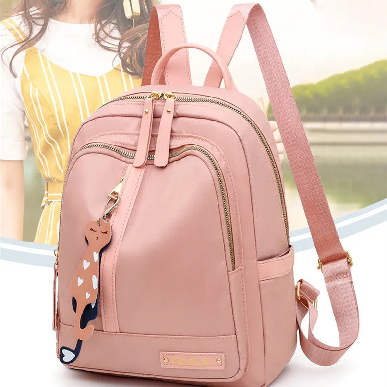 Black women's casual nylon backpack showing square vertical shape with shoulder straps and external pockets