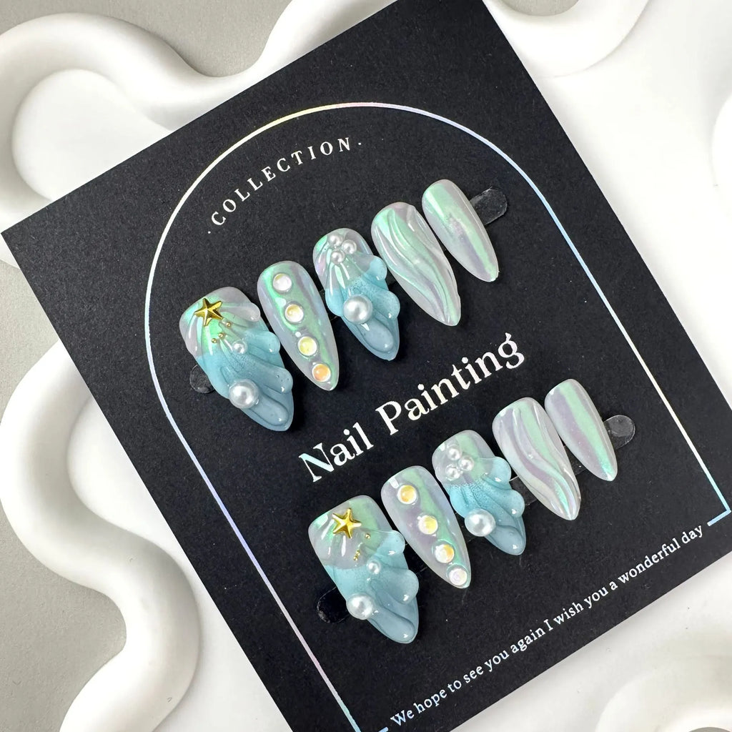 Blue plastic artificial nail tips set on a card, showing sizes labelled XS, S, M, and L.