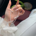 White imitation pearl necklace for women with an adjustable chain and a geometric sweet bow charm.