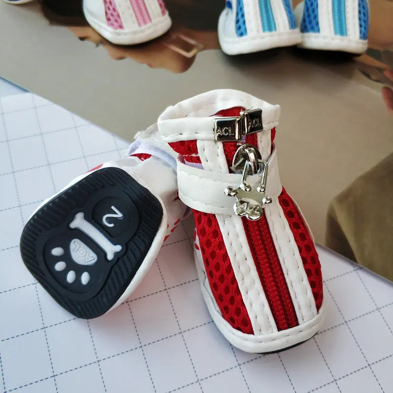 Set of four blue cloth dog shoes with zipper closures and non-slip soles for small pets.