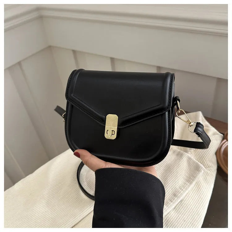 Soft PU messenger bag with textured finish and clamshell opening in horizontal square shape