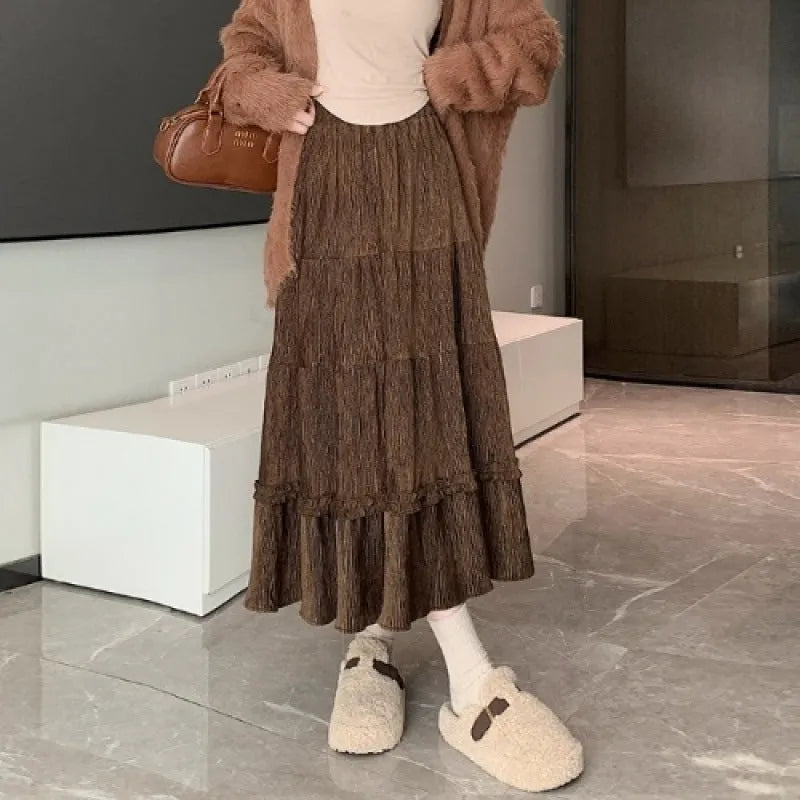 Korean-style solid colour corduroy A-line midi skirt with an elastic waistband.