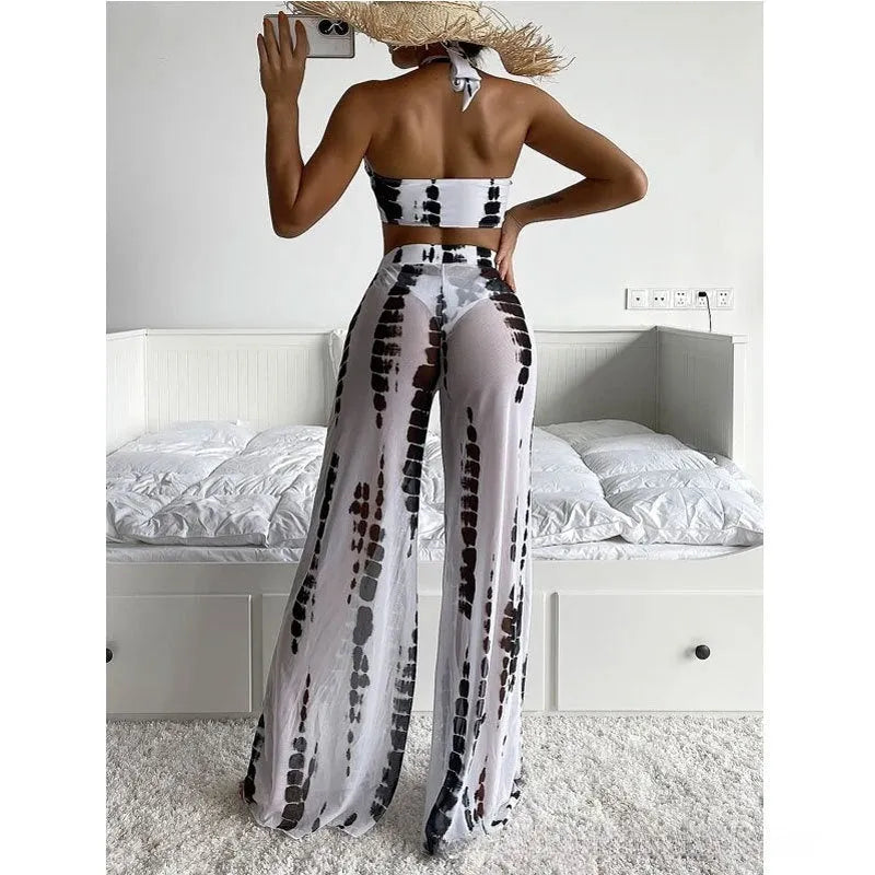 Women's three-piece swimsuit set showing bikini top, underpants, and mesh trousers in printed fabric
