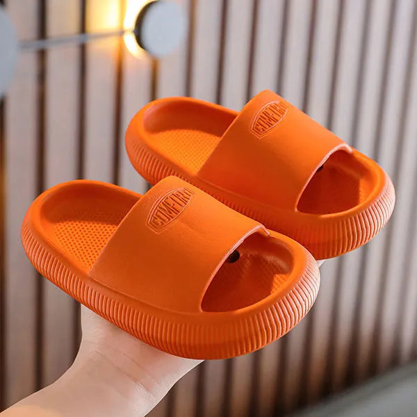 Colourful children's EVA slippers with a thick, textured non-slip sole in various sizes.