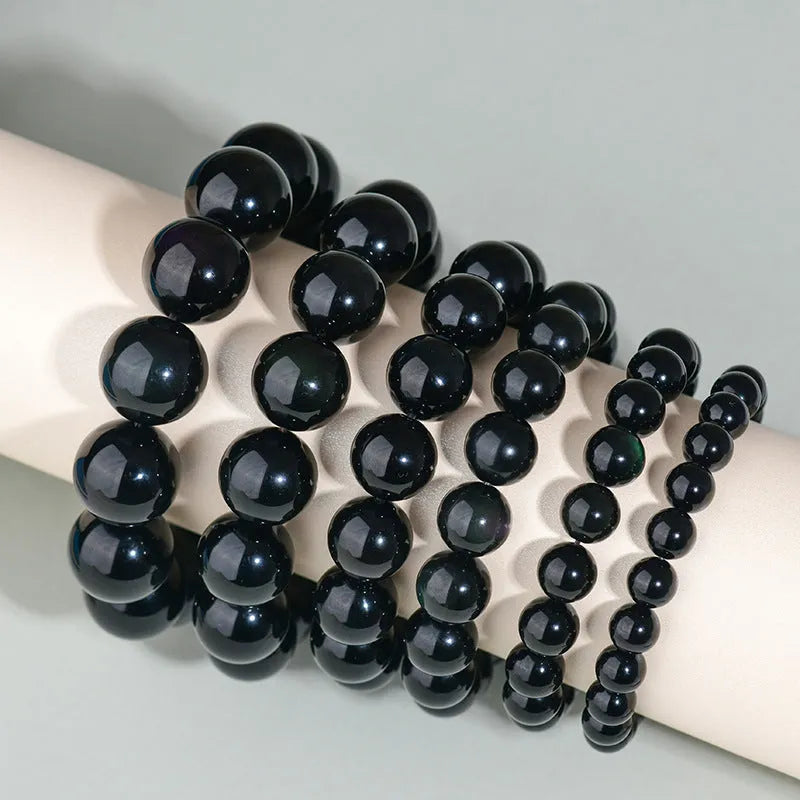 Hand-woven obsidian bracelet with round crystal beads in natural black stone