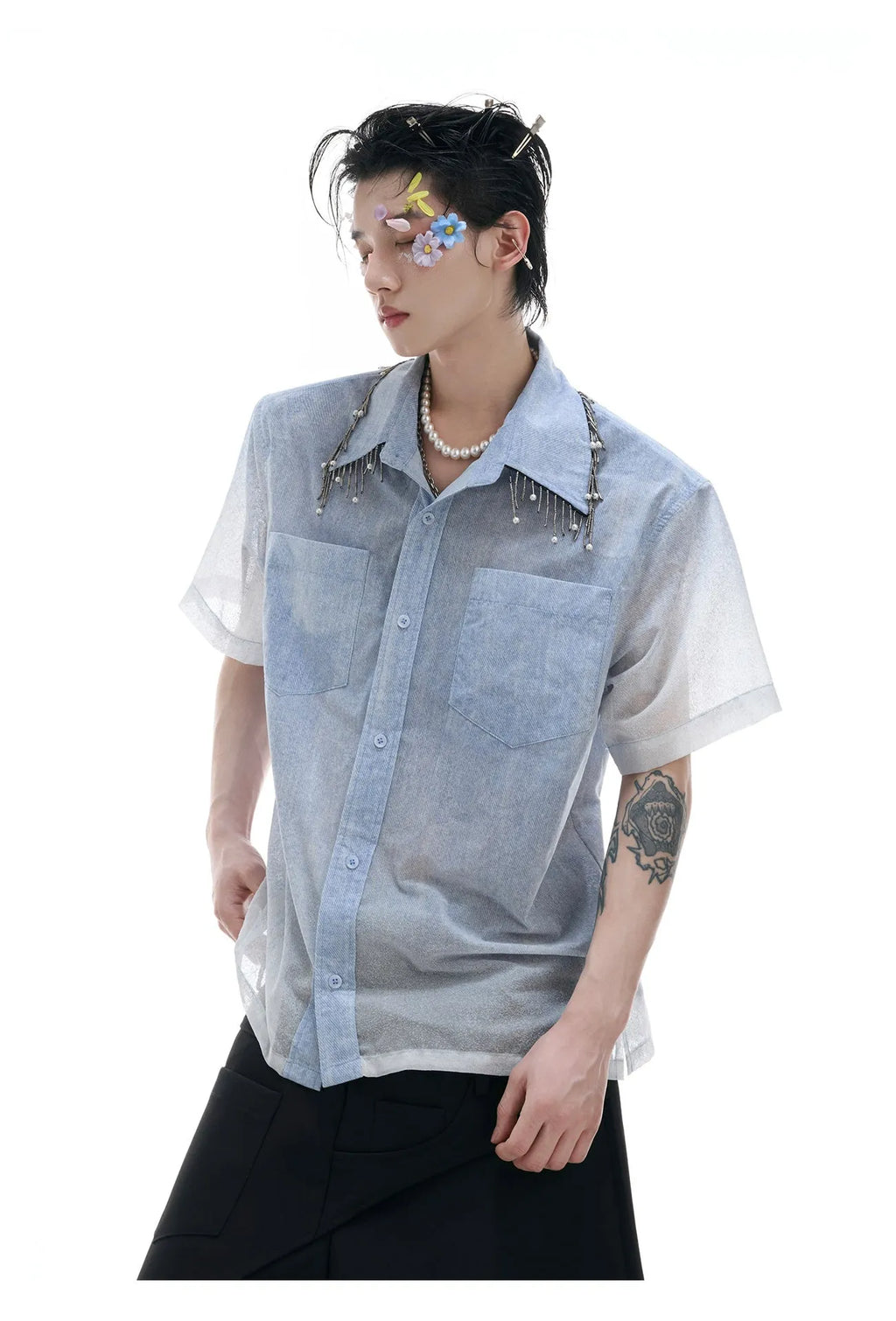 Man wearing a loose fit blue and white gradient short sleeve shirt with quilted details