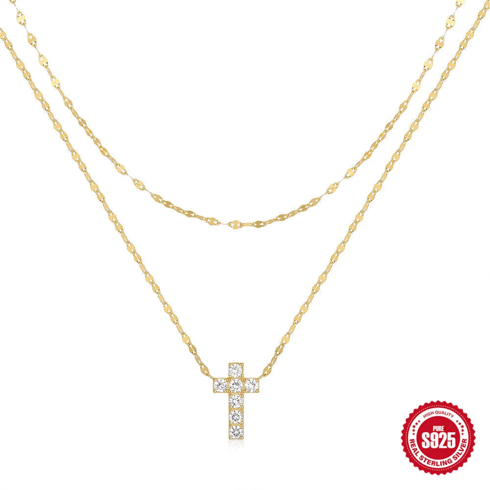Sterling silver geometric cross pendant necklace with double layer design and diamond detailing on clavicle chain