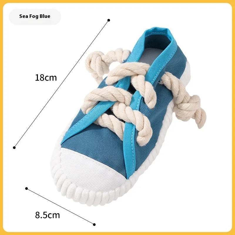 Slipper-shaped plastic dog chew toy in three colours with bends for chewing