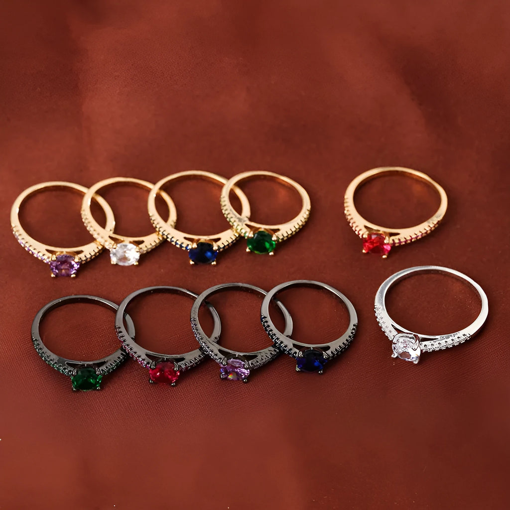 A geometric hexagonal zircon ring in copper, shown in a gold rose red electroplated finish on a size 7 finger.