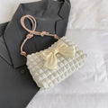 Women's black canvas handbag with single shoulder strap showing horizontal square shape and sandwich pocket