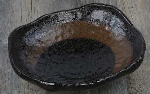 Japanese coarse pottery sashimi bowl with irregular shape and floral glaze decorations