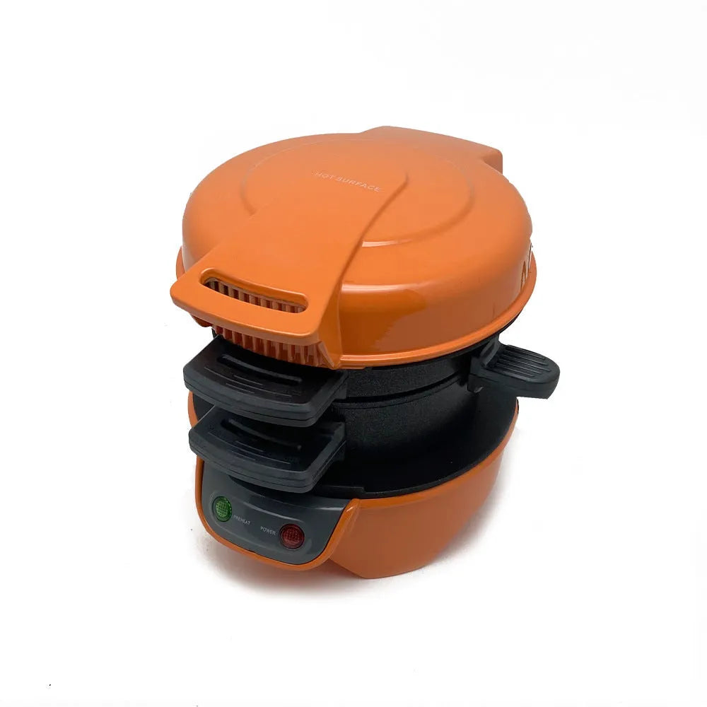 Bright red breakfast sandwich maker with egg cooker ring and baking trays on kitchen counter