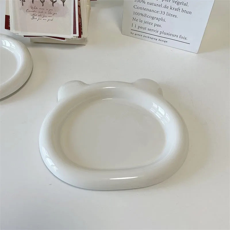 White ceramic plate with bear doodle design, 20cm diameter, on a table.