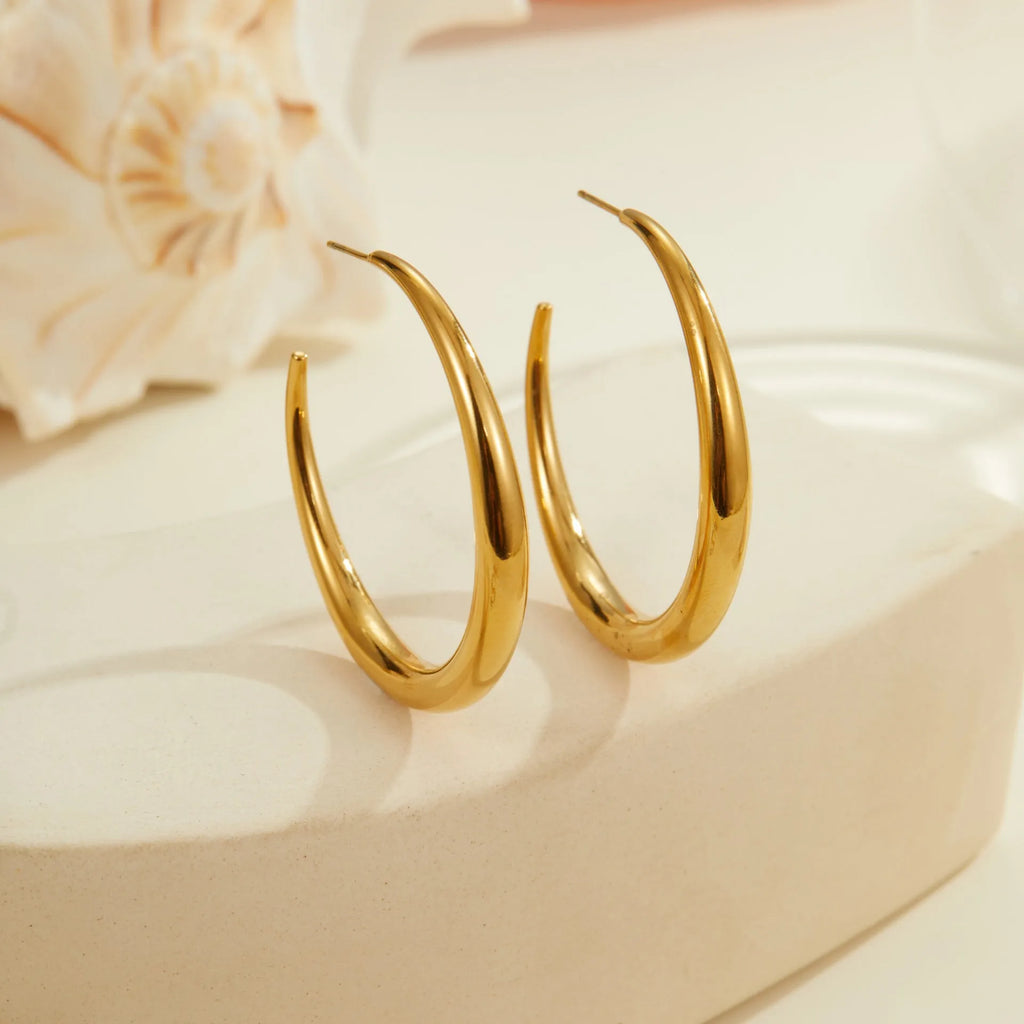 Geometric round hoop earrings in titanium steel with 18K gold plating, available in small and large sizes