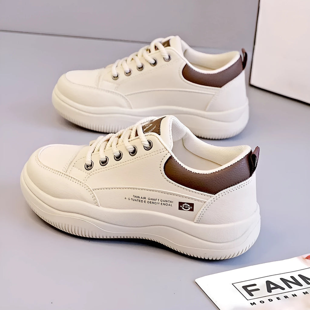 Women's white Korean-style casual shoes with cross strap detail and a synthetic leather upper.