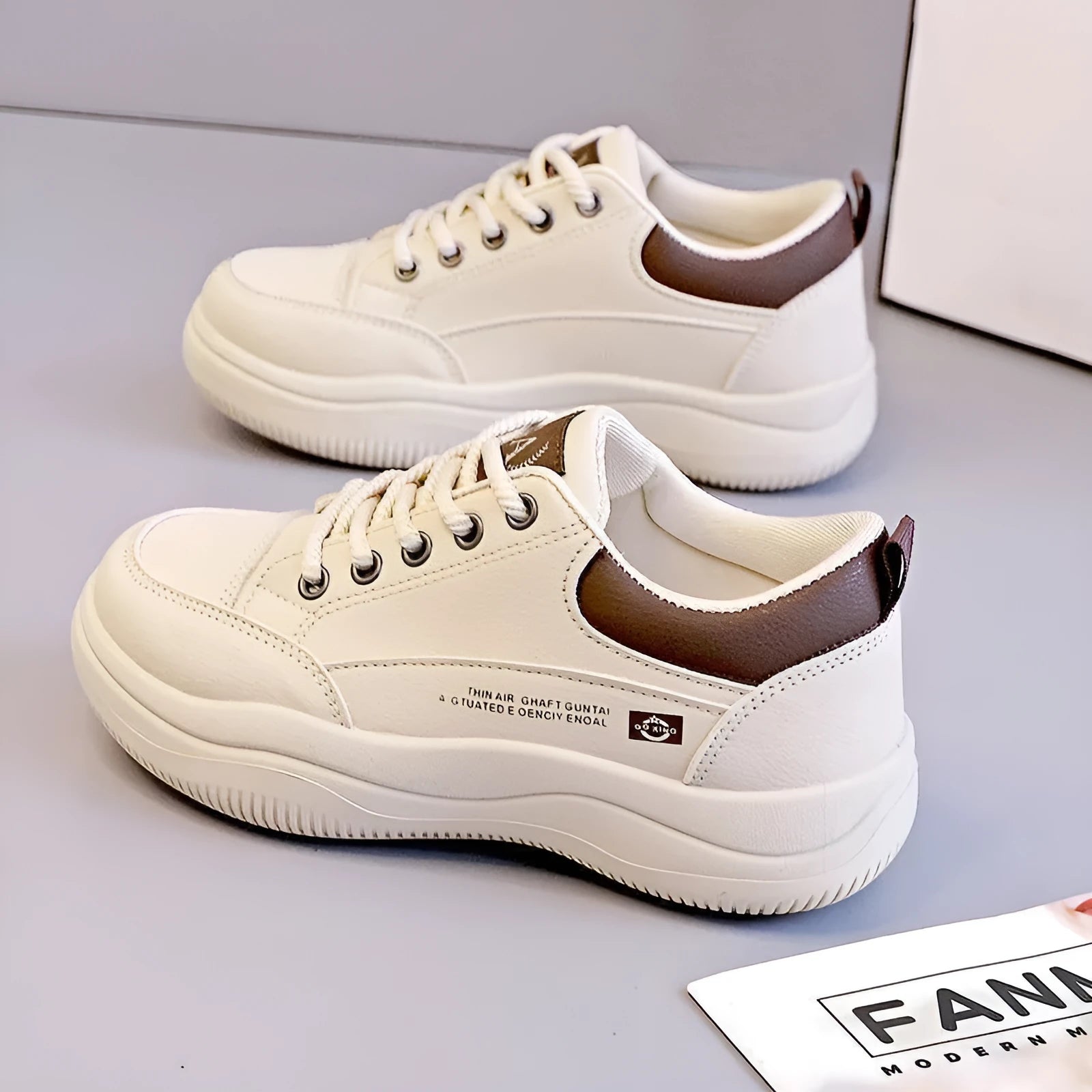Women's white Korean-style casual shoes with cross strap detail and a synthetic leather upper.