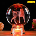 White luminous crystal ball ornament with Chinese zodiac animal figure on electronic base.