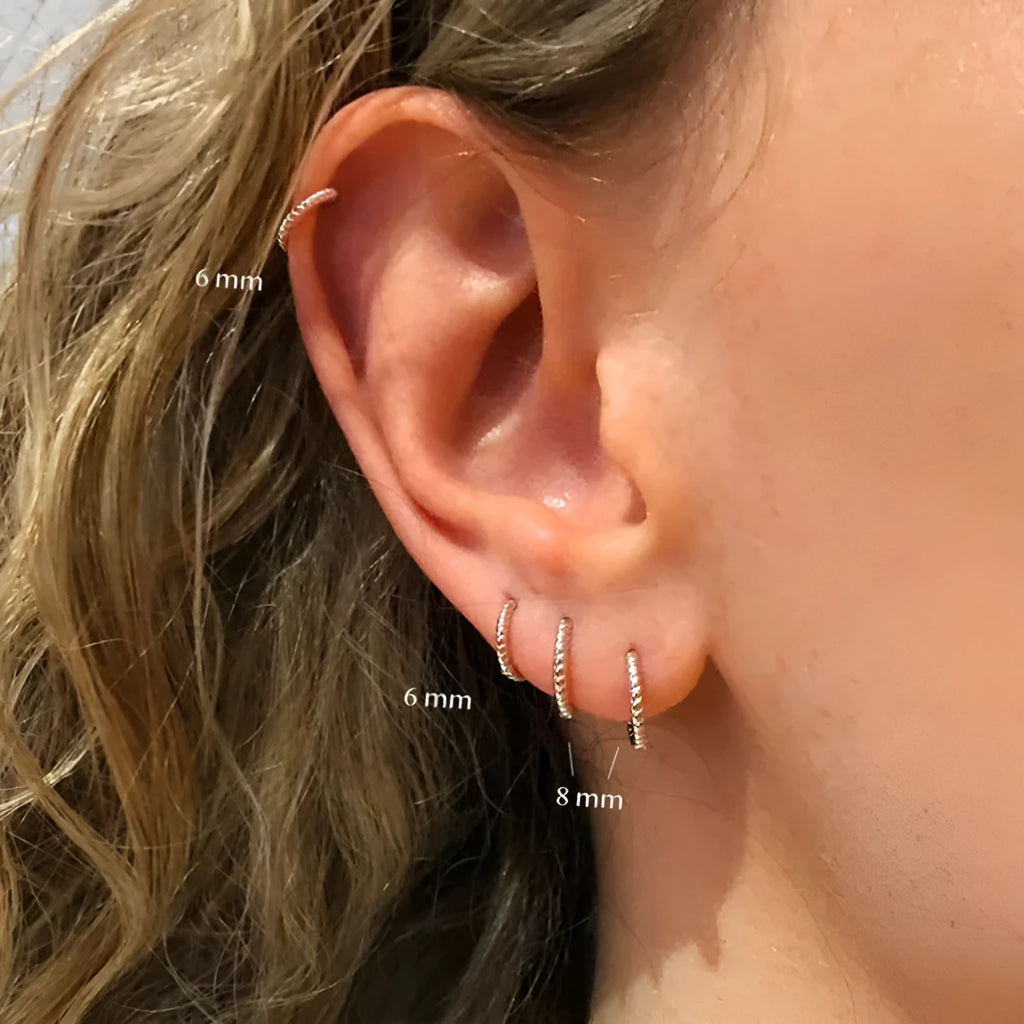 Twisted sterling silver round ring earrings in gold and white gold finishes showing multiple sizes