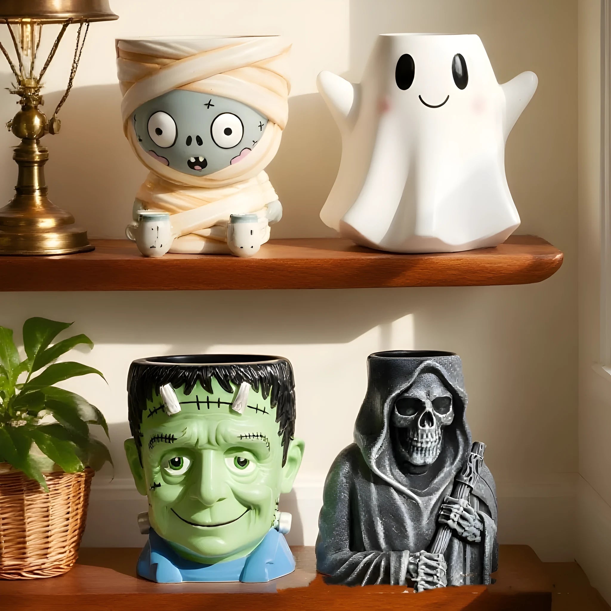 Hand-painted Halloween resin flower pot decorations showing bandage zombie, death, Frankenstein, and white ghost cartoon designs