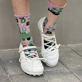 Women's silver lace-up sports shoes with a bow detail and a mid-height heel on a white background.
