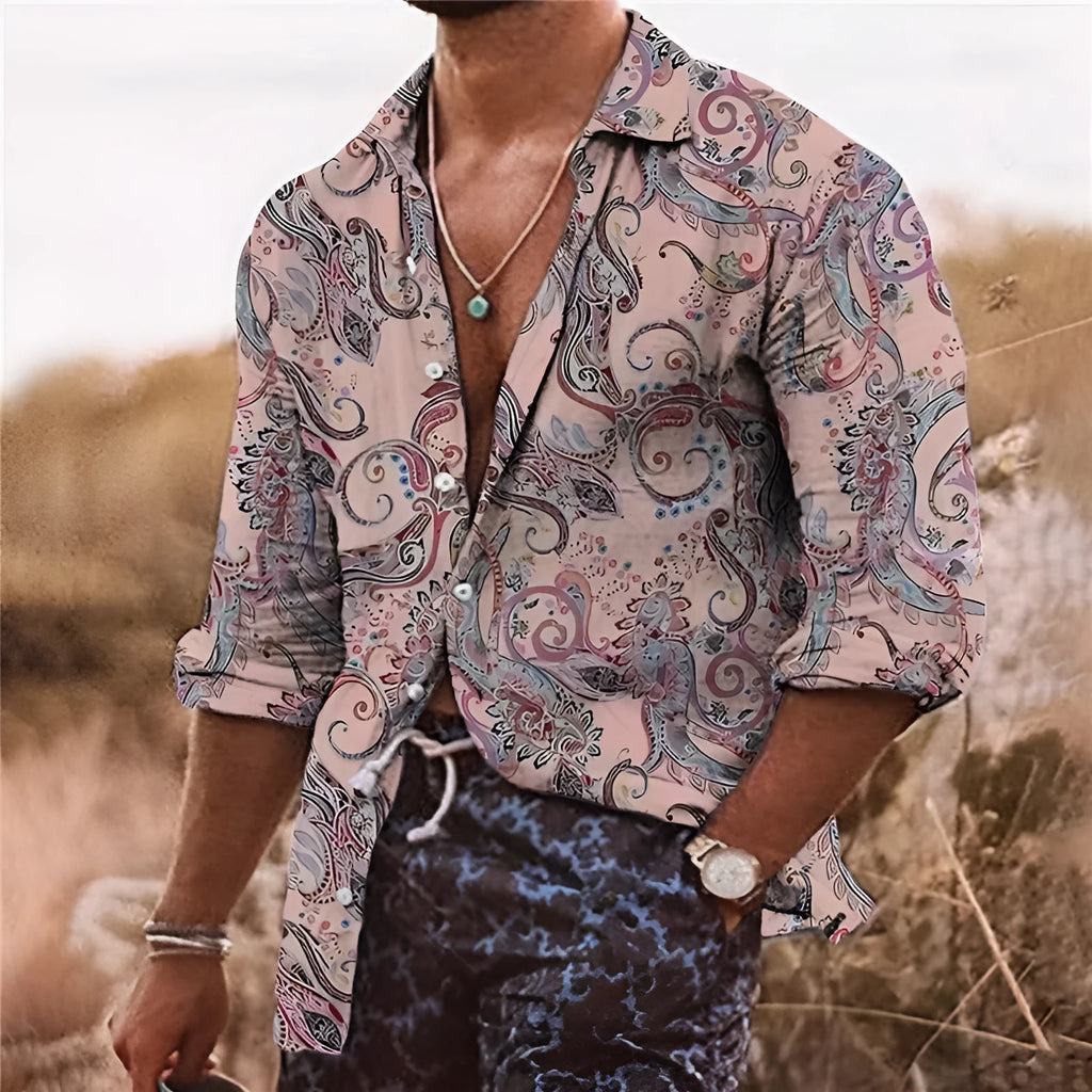 Man wearing a loose-fit long sleeve shirt with a colourful bohemian floral 3D print pattern.