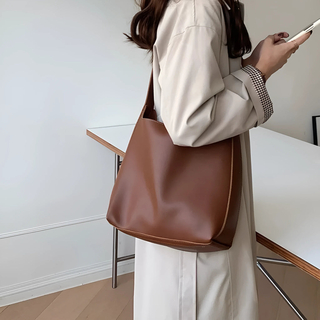 Soft black and brown PU leather ladies shoulder bags with swing thread decorative detail.