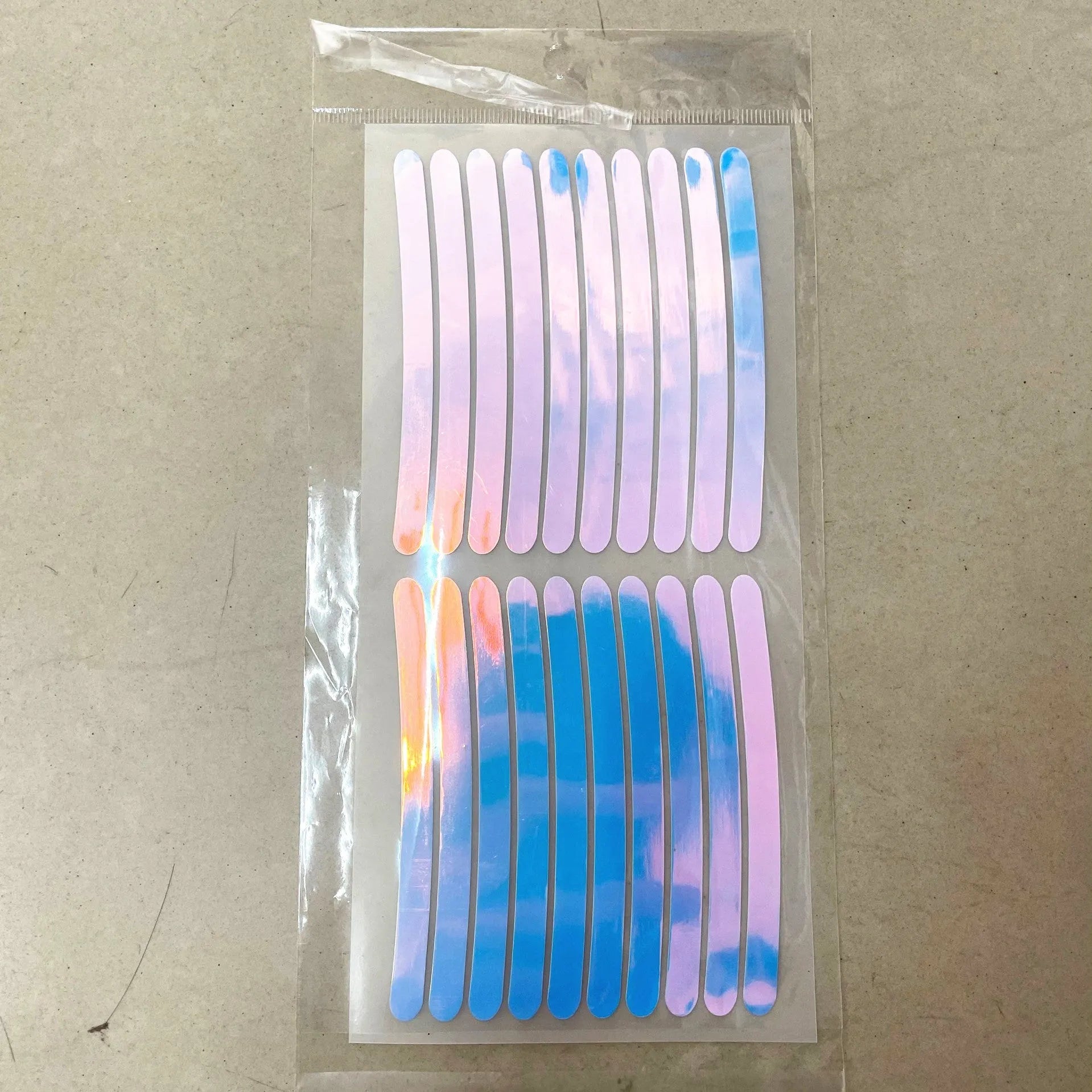 Pack of 20 arc-shaped PVC reflective stickers for car wheel hubs in assorted high-visibility colours.