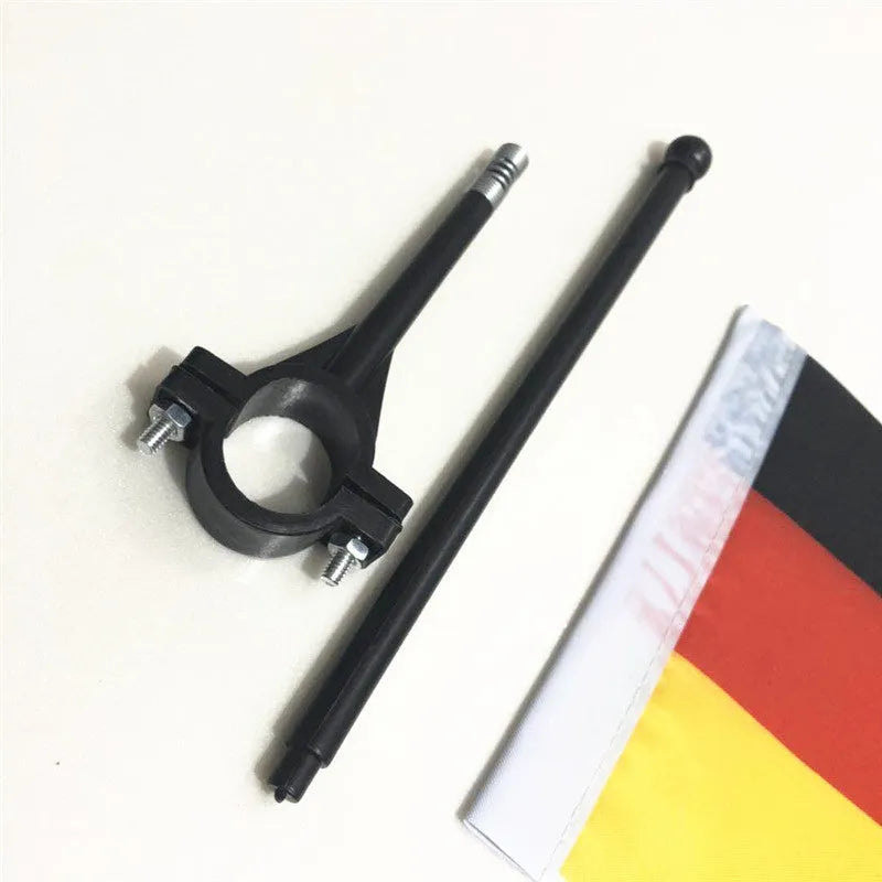Square polyester flag on a plastic handlebar pole attached to a bicycle.