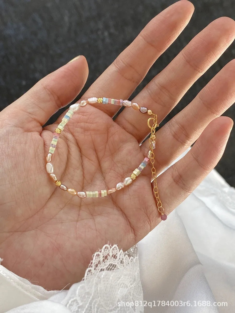 Women's natural pearl bracelet and necklace set with 14K gilded purple silver pieces and irregular U-shaped pearls.