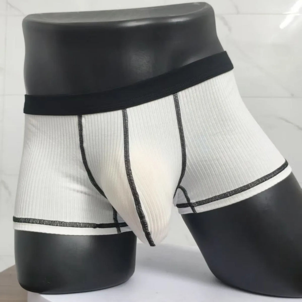 Men's thin fabric boxer shorts in solid colours showing hip lifting design