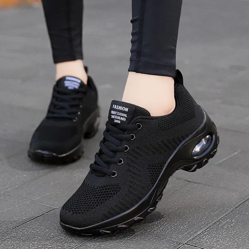 Women's red and black mesh front lace-up low top sneakers with round toe and flat mid-heel on a white background.