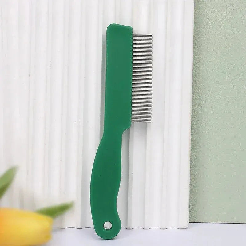 Green plastic handle stainless steel pet flea comb for dogs and cats on a plain background.