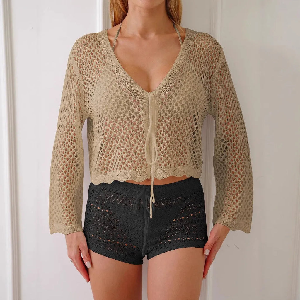Women's apricot coloured hollow woven blouse with short length and bell sleeves on a hanger.