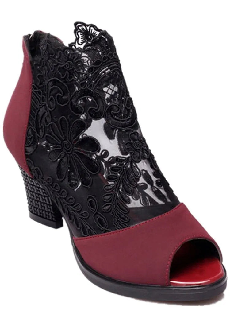 Women's black gladiator sandals with square heels and flower lace upper showing zip closure detail