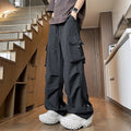 Women's plus size loose-fit waterproof trousers in black, shown with elasticated waist and straight leg.