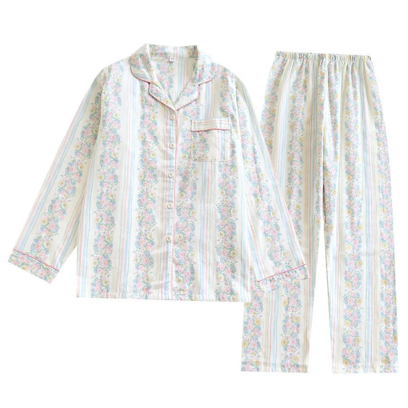 Red and white small fruit patterned cotton gauze long-sleeved top and trousers homewear set laid flat.