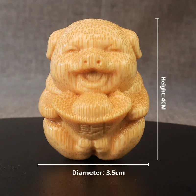 Solid bamboo carving pig ornament measuring 4cm height by 3.5cm diameter