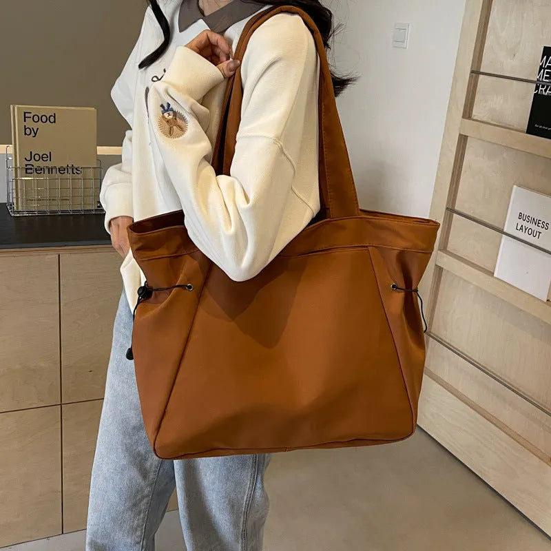 Oxford cloth folding tote bag in five colour options: black, brown, dark grey, light grey and purple.