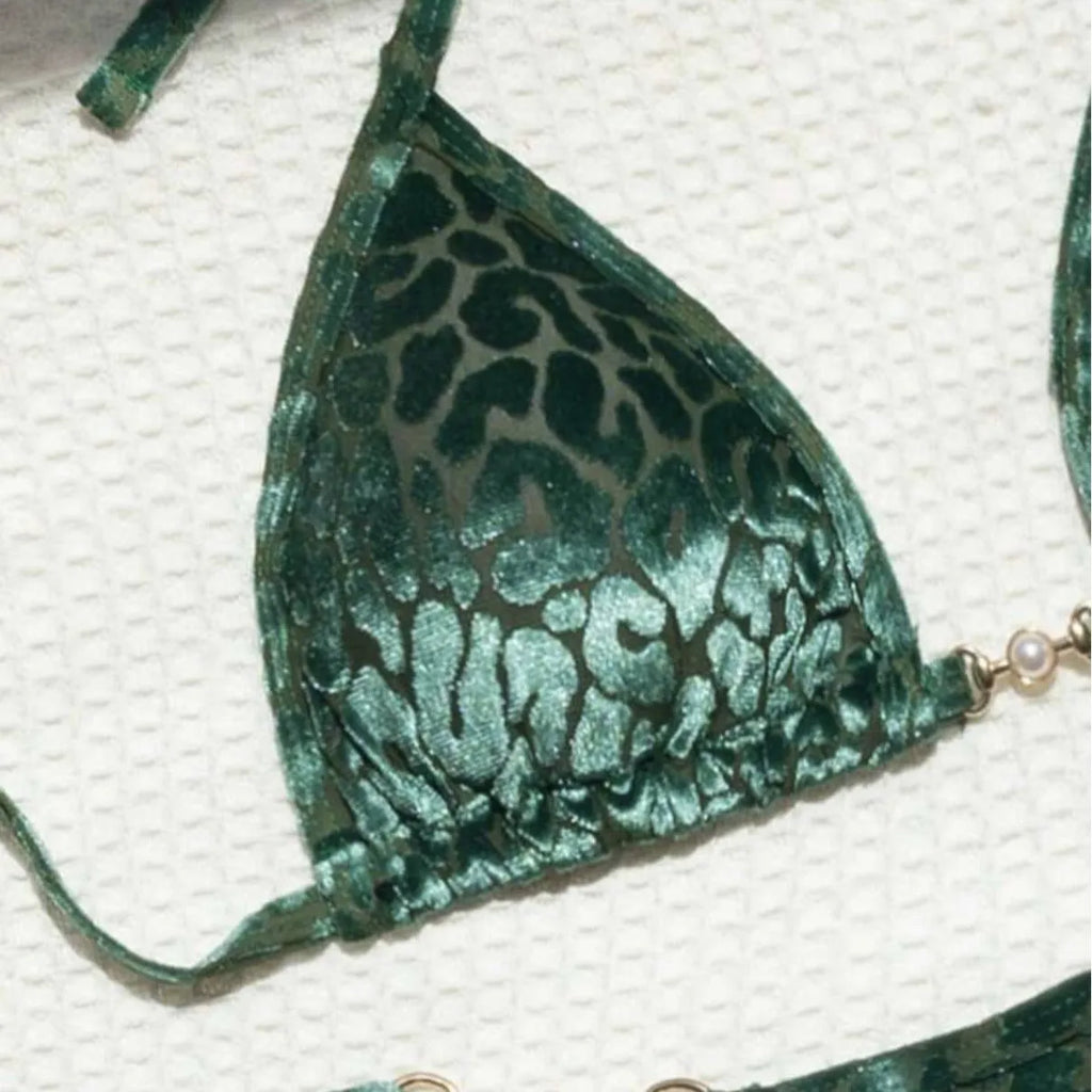 Blue and green leopard print women's bikini set on a mannequin, showing T-shaped design.