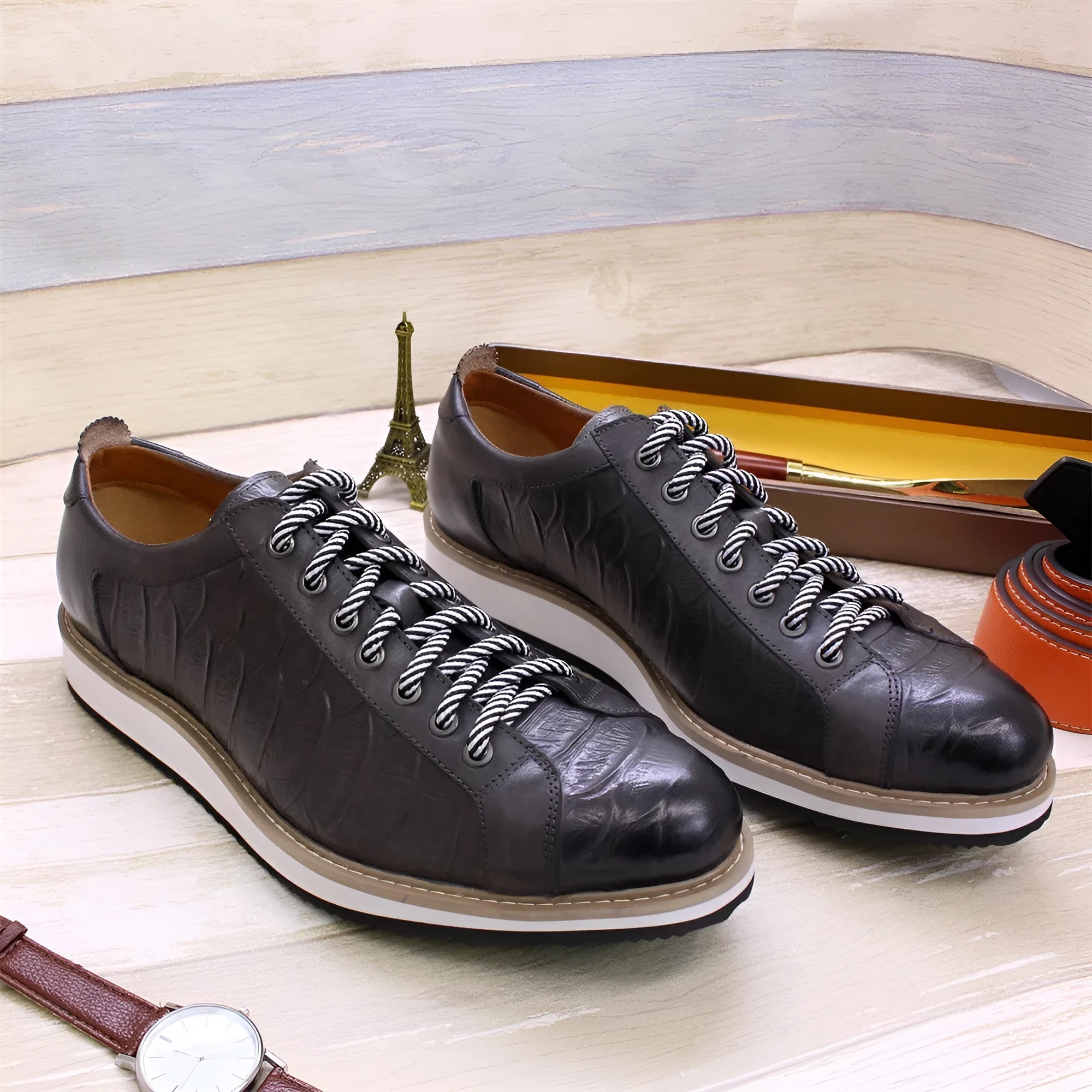 Men's black pattern-embossed handmade low-top shoes with front tie style on a white background.